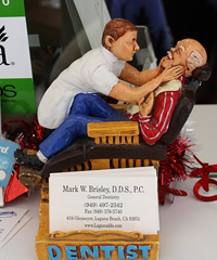 Image: Dr. Brisley's business card holder featuring a dentist and his patient